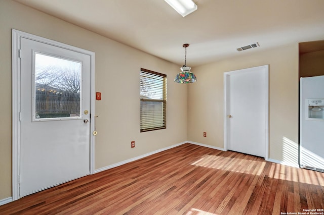 interior space with visible vents, baseboards, and light wood-style floors