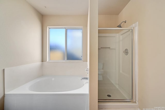 bathroom with a garden tub and a stall shower