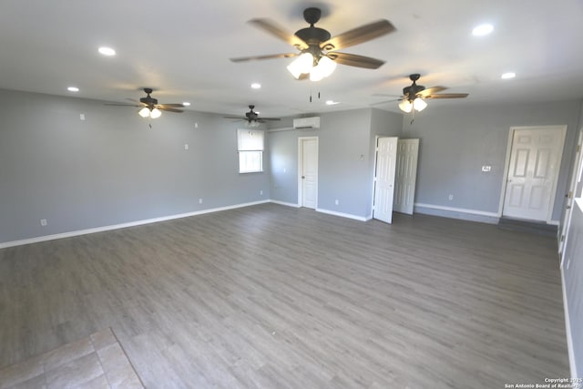 empty room featuring recessed lighting, baseboards, wood finished floors, and ceiling fan