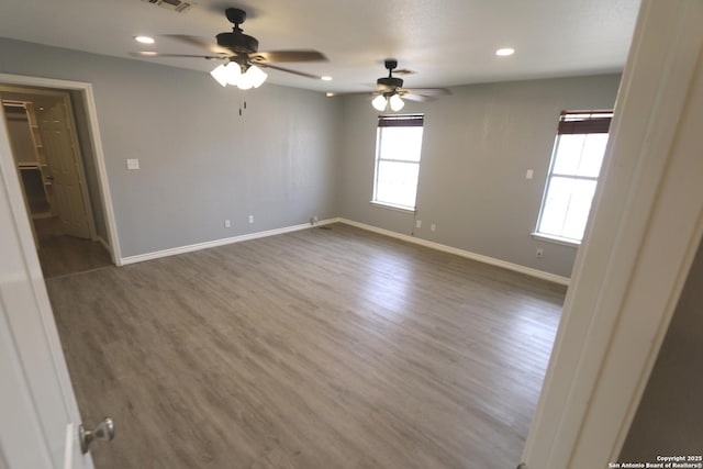 empty room with visible vents, baseboards, recessed lighting, wood finished floors, and a ceiling fan