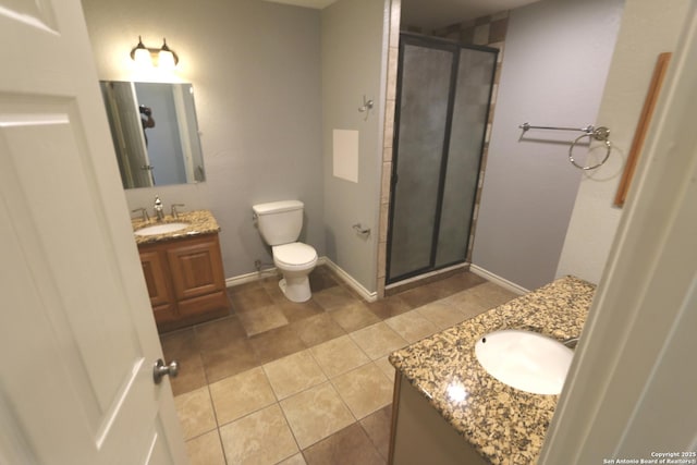 bathroom with baseboards, toilet, a stall shower, and vanity