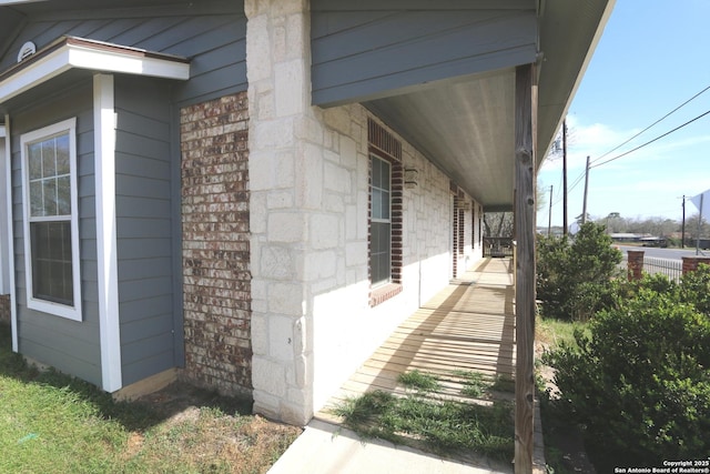 view of property exterior with brick siding and stone siding