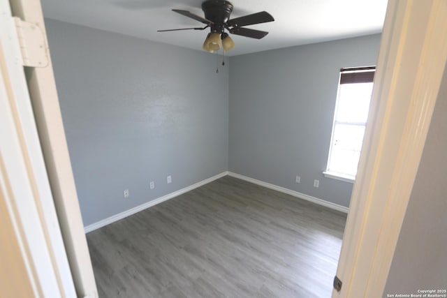 unfurnished room with wood finished floors, baseboards, and ceiling fan