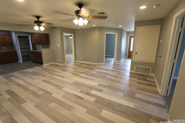 unfurnished living room featuring visible vents, baseboards, recessed lighting, light wood-style floors, and a ceiling fan