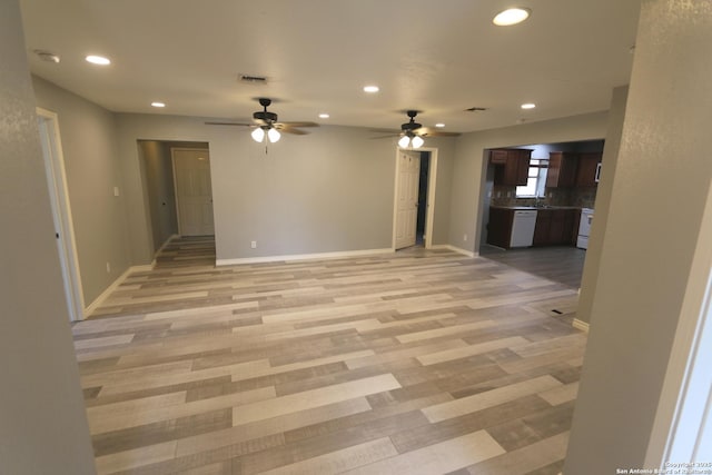 unfurnished living room with visible vents, a ceiling fan, recessed lighting, light wood finished floors, and baseboards