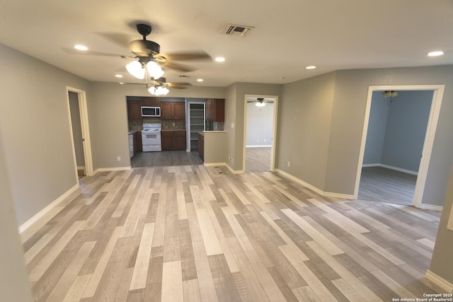 unfurnished living room featuring recessed lighting, light wood-style flooring, and a ceiling fan