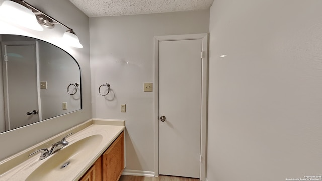 bathroom featuring vanity and a textured ceiling