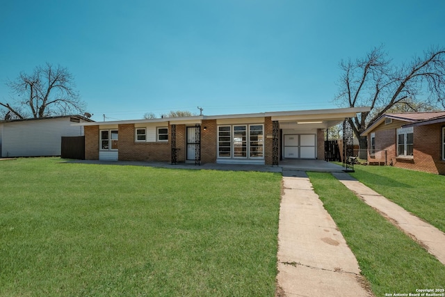 view of front of house featuring concrete driveway, an attached garage, brick siding, and a front yard