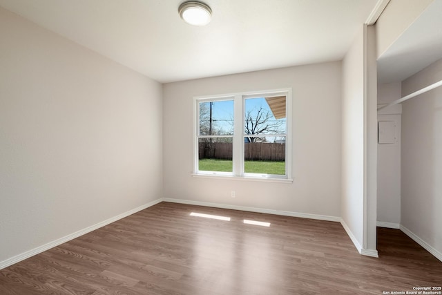 unfurnished bedroom with baseboards and wood finished floors