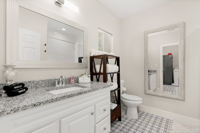 bathroom with a shower with curtain, toilet, baseboards, washer / dryer, and vanity