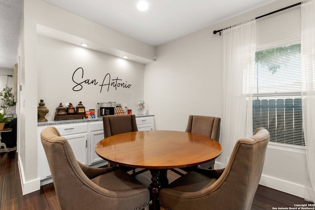 dining area with dark wood finished floors, recessed lighting, and baseboards