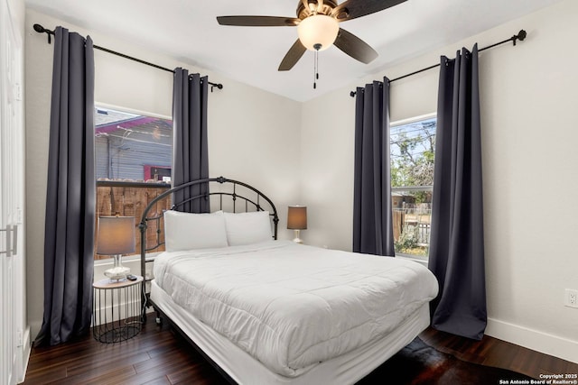 bedroom featuring ceiling fan, baseboards, and wood finished floors