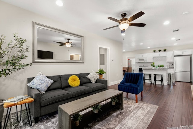 living area featuring visible vents, electric panel, recessed lighting, ceiling fan, and dark wood-style flooring