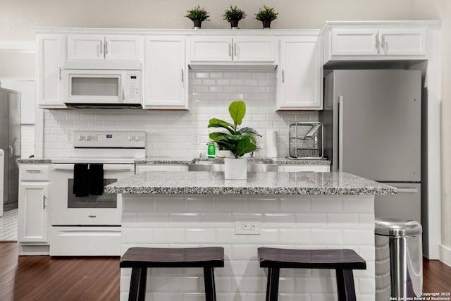 kitchen featuring dark wood-style floors, white appliances, and white cabinetry