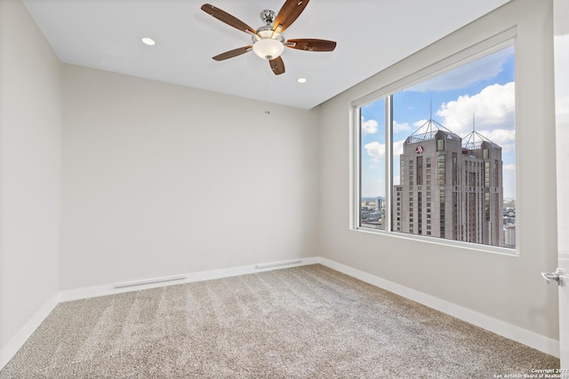 carpeted spare room with recessed lighting, baseboards, and ceiling fan