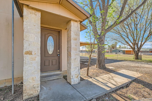 view of exterior entry featuring stone siding