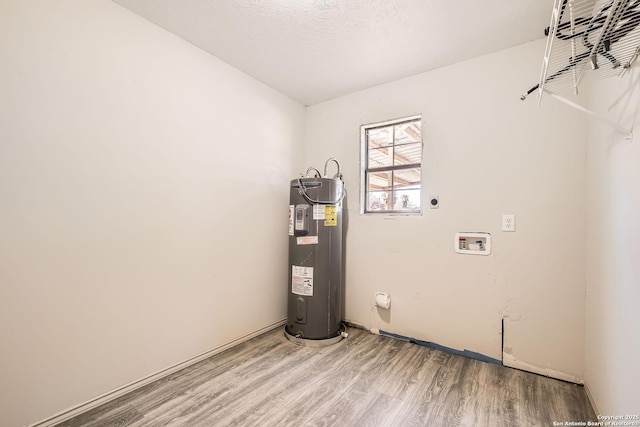 laundry area with light wood finished floors, electric water heater, laundry area, hookup for a washing machine, and hookup for an electric dryer