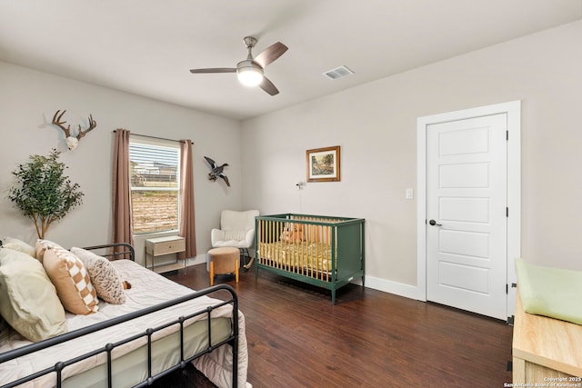 bedroom featuring visible vents, baseboards, wood finished floors, and a ceiling fan