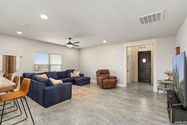 living room featuring recessed lighting, visible vents, baseboards, and ceiling fan