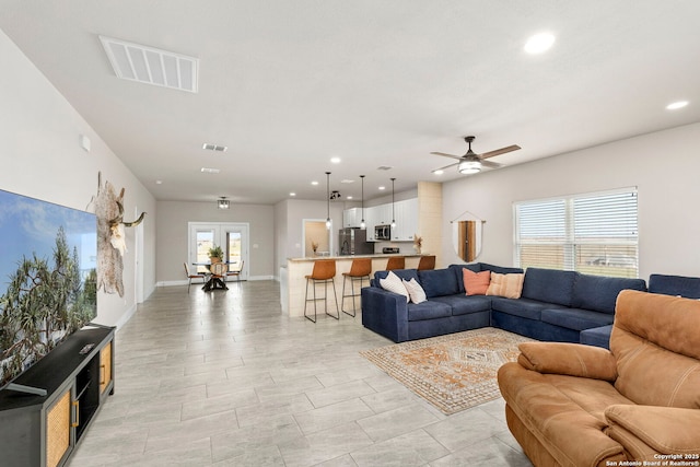 living room with visible vents, recessed lighting, baseboards, and ceiling fan