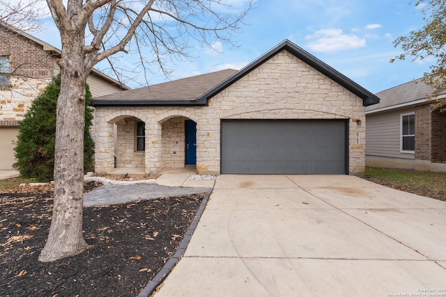 french provincial home with a shingled roof, a porch, driveway, stone siding, and an attached garage