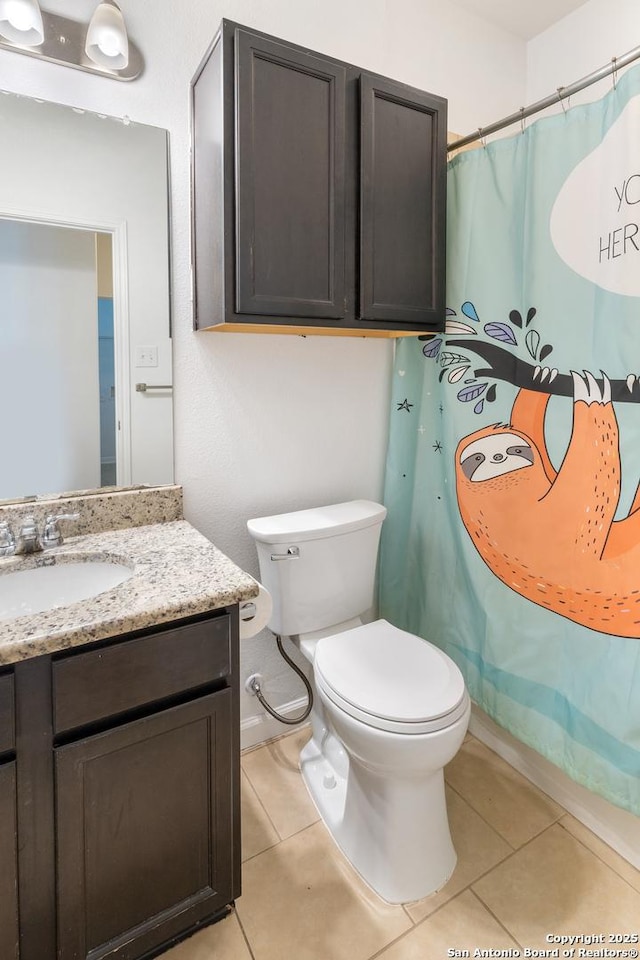 bathroom featuring tile patterned flooring, toilet, vanity, and a shower with shower curtain