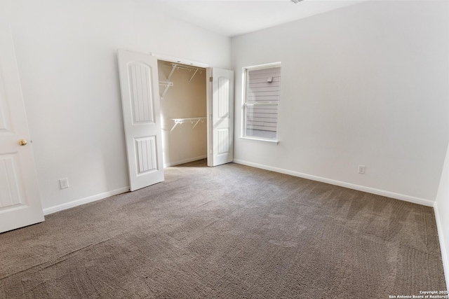 unfurnished bedroom featuring a closet, baseboards, and carpet