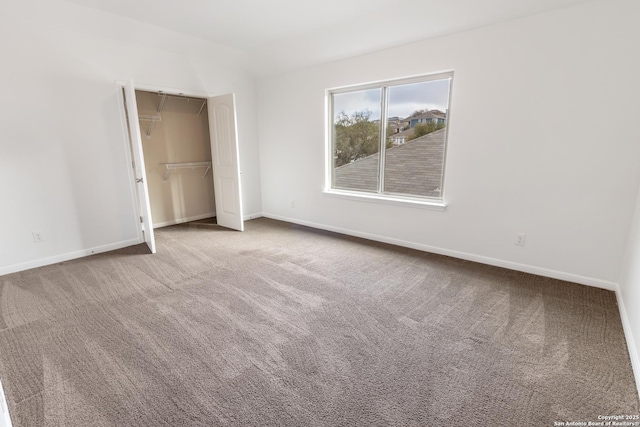 unfurnished bedroom featuring a closet, baseboards, and carpet flooring