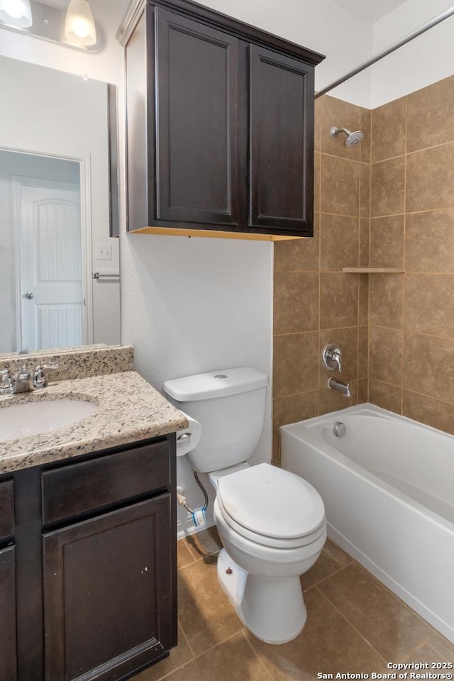 bathroom featuring vanity, tile patterned floors, toilet, and tub / shower combination