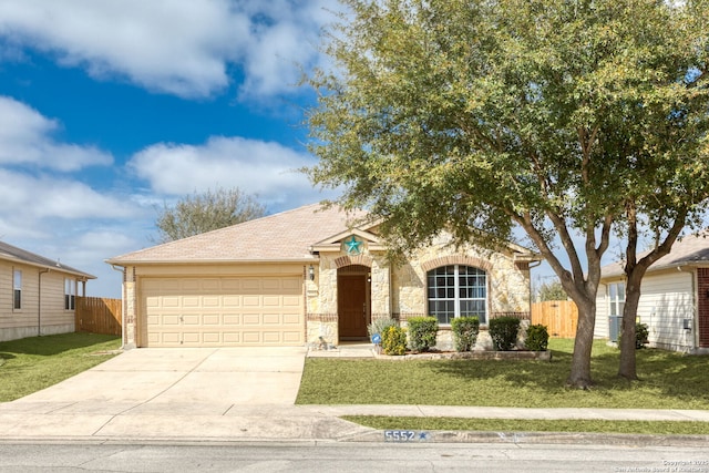 view of front facade featuring a front yard, driveway, and fence