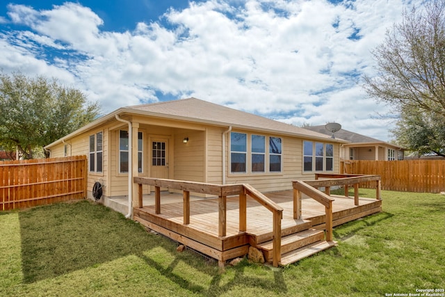 back of house featuring a yard, a deck, and fence