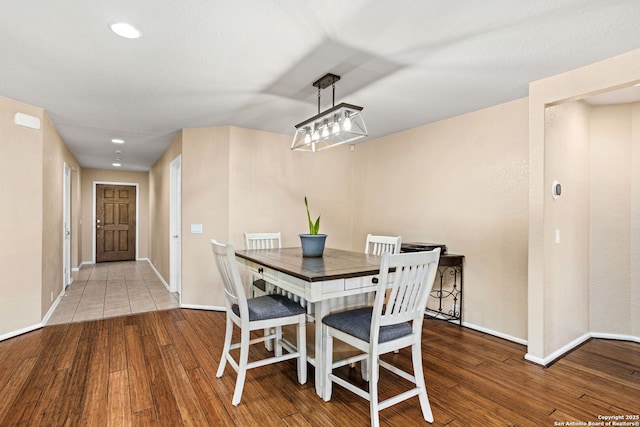 dining room with recessed lighting, baseboards, and wood finished floors