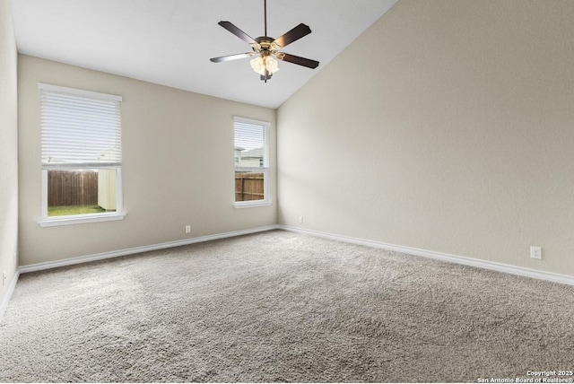 carpeted empty room featuring baseboards, lofted ceiling, and a ceiling fan