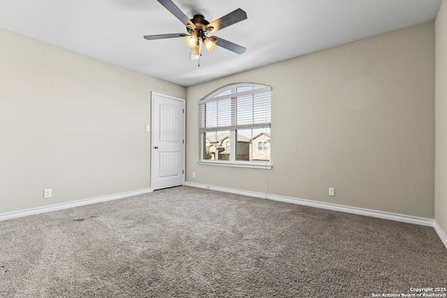 carpeted empty room with baseboards and ceiling fan