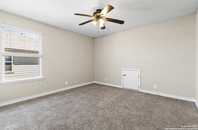 carpeted empty room featuring a ceiling fan and baseboards