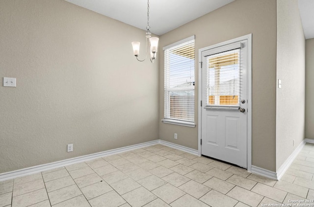 interior space with light tile patterned floors, baseboards, and a chandelier