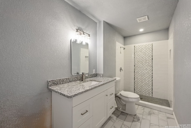 full bathroom with visible vents, toilet, a stall shower, a textured wall, and a textured ceiling