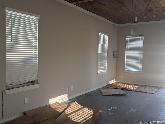 unfurnished room with wood ceiling and concrete flooring