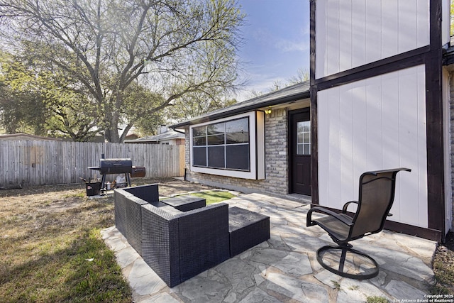 view of patio / terrace featuring area for grilling, a fenced backyard, and an outdoor hangout area