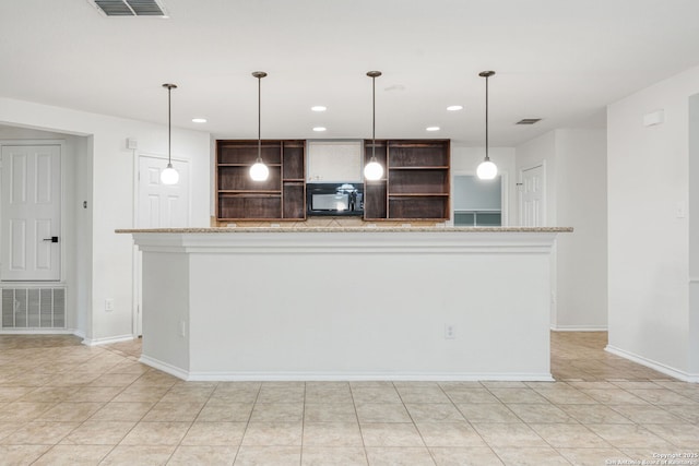 kitchen featuring visible vents, pendant lighting, black microwave, and open shelves