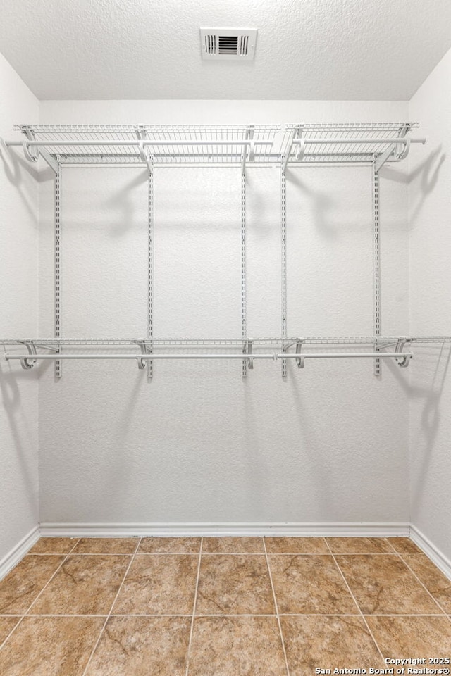 spacious closet with visible vents and tile patterned flooring