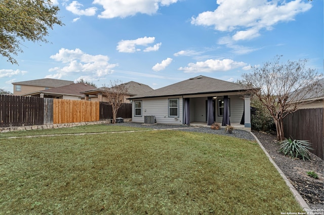 back of house featuring a patio, cooling unit, a lawn, and a fenced backyard