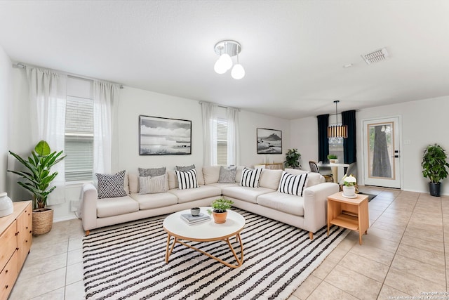 living area with visible vents and light tile patterned flooring