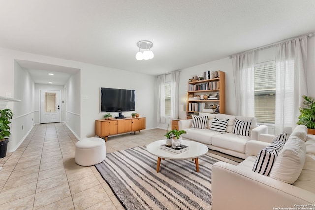 living room featuring light tile patterned floors and baseboards