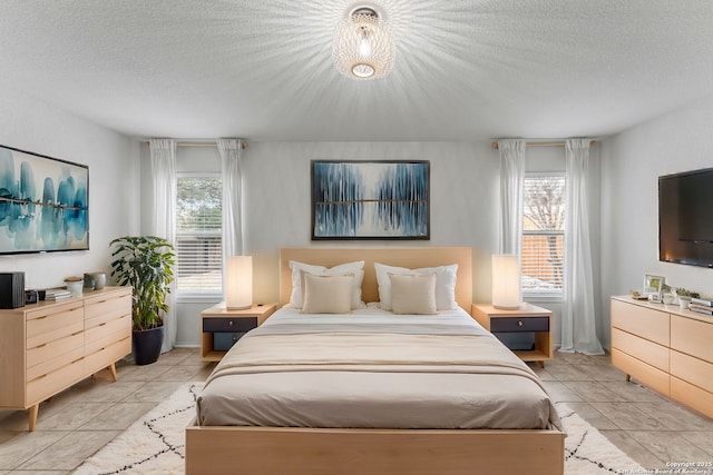 bedroom featuring a textured ceiling and light tile patterned flooring