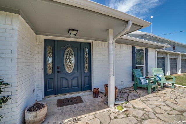 doorway to property with brick siding