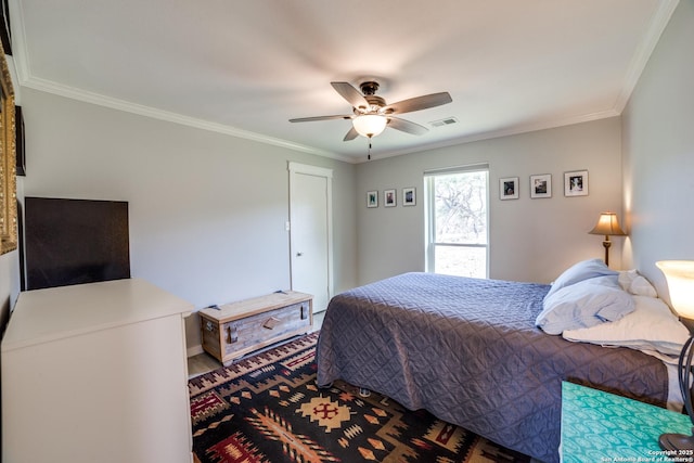 bedroom featuring visible vents, ceiling fan, and crown molding