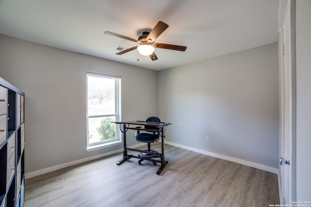 office featuring baseboards, ceiling fan, and light wood finished floors