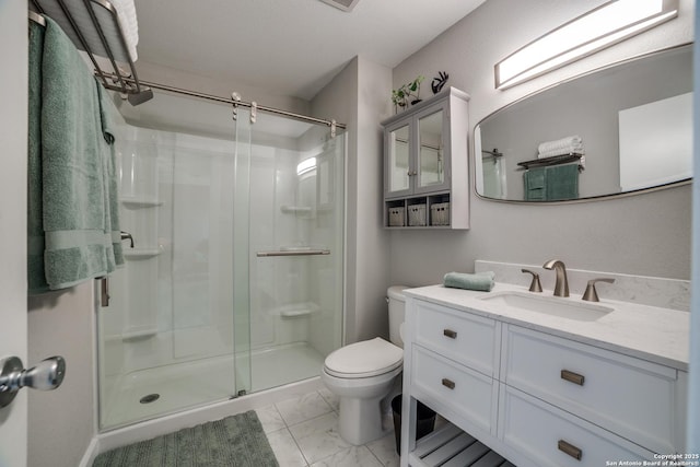 bathroom featuring vanity, toilet, marble finish floor, and a shower stall