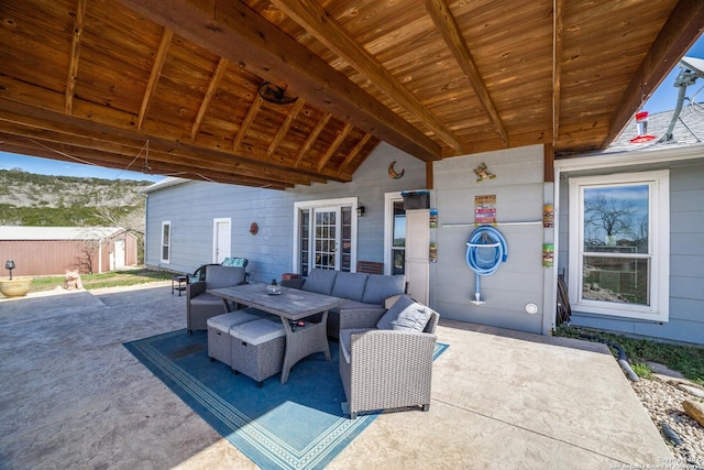 view of patio / terrace featuring an outdoor structure, a storage unit, and an outdoor hangout area